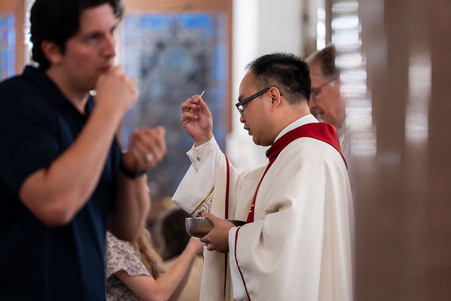 Fr. Nguyen distributes communion